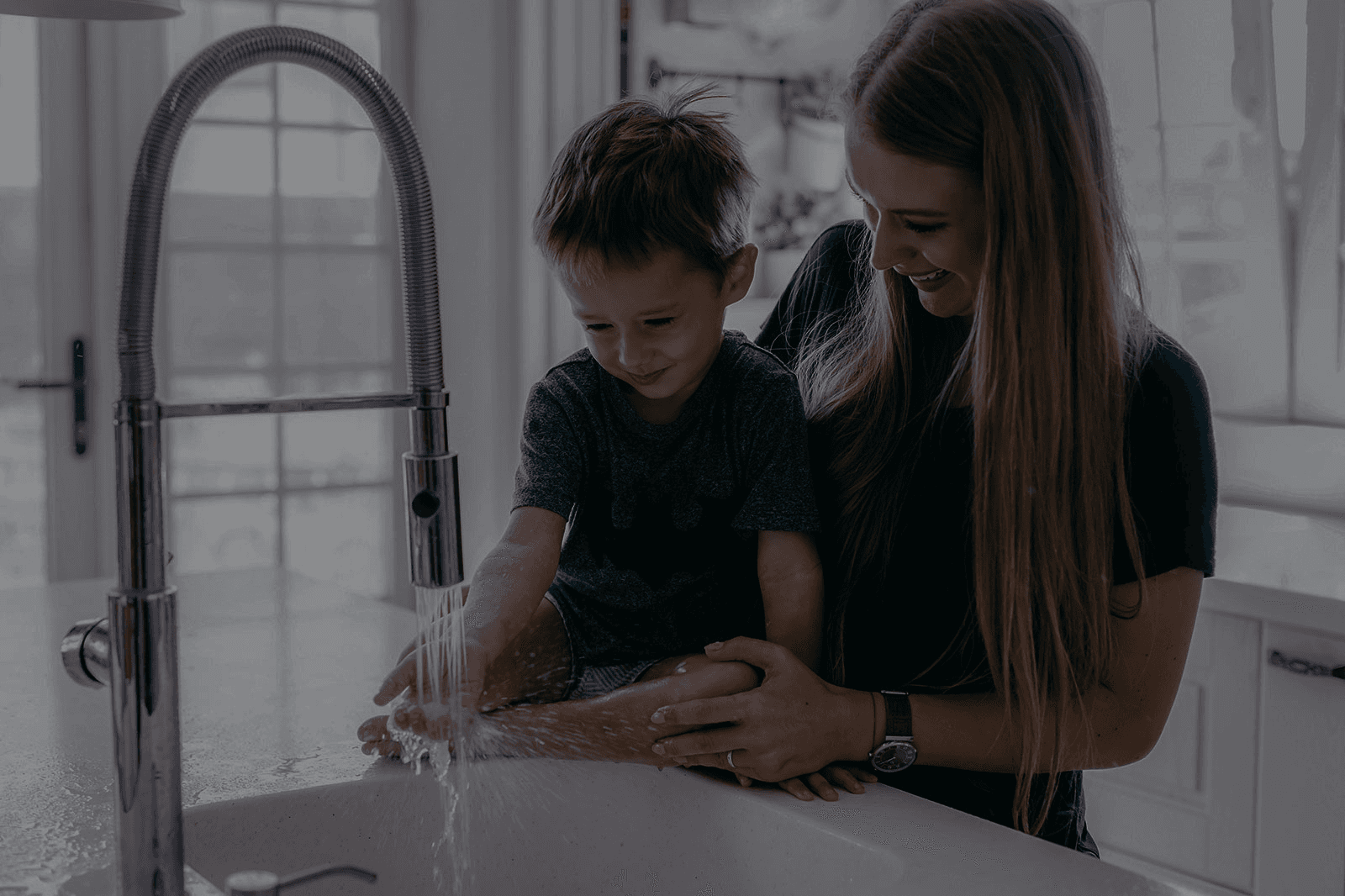 family using water at sink - darkened