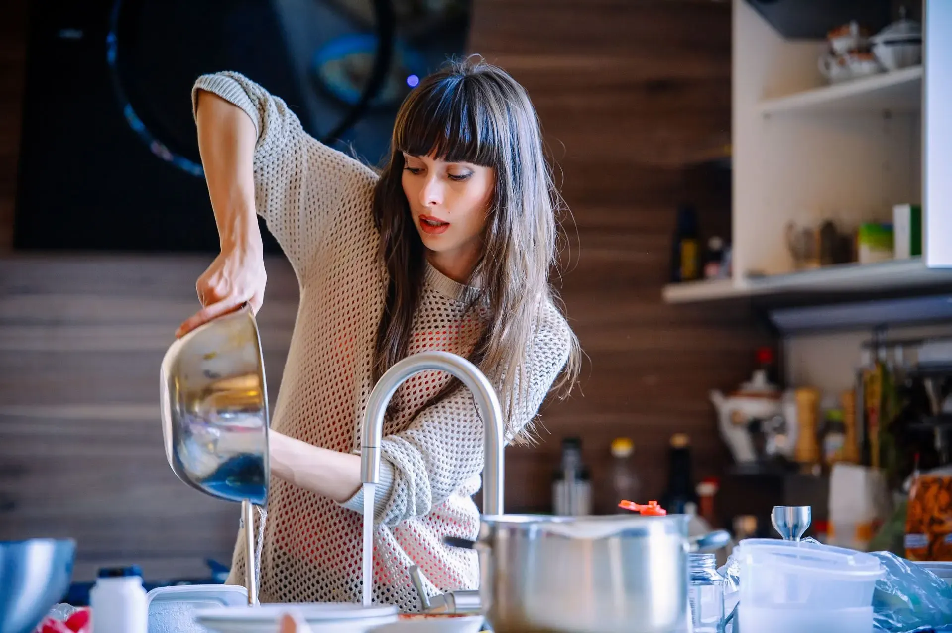 Person using sink in kitchen - water treatment
